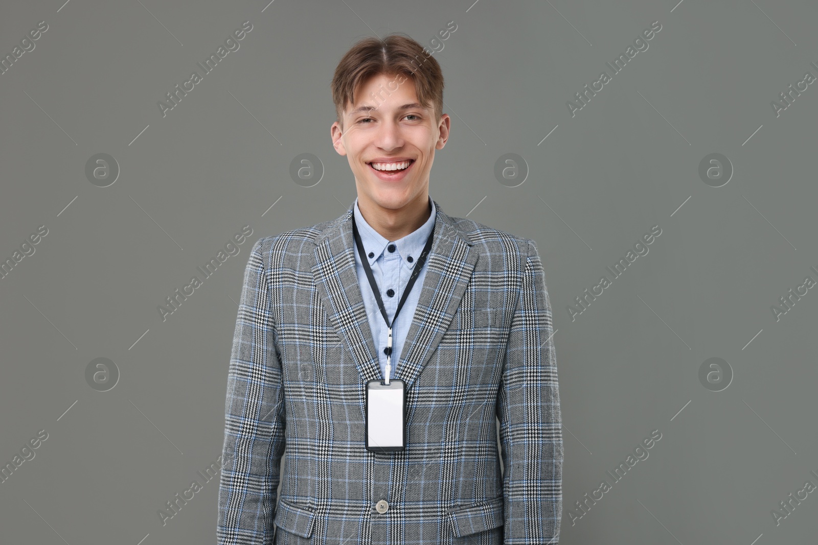 Photo of Happy man with blank badge on grey background