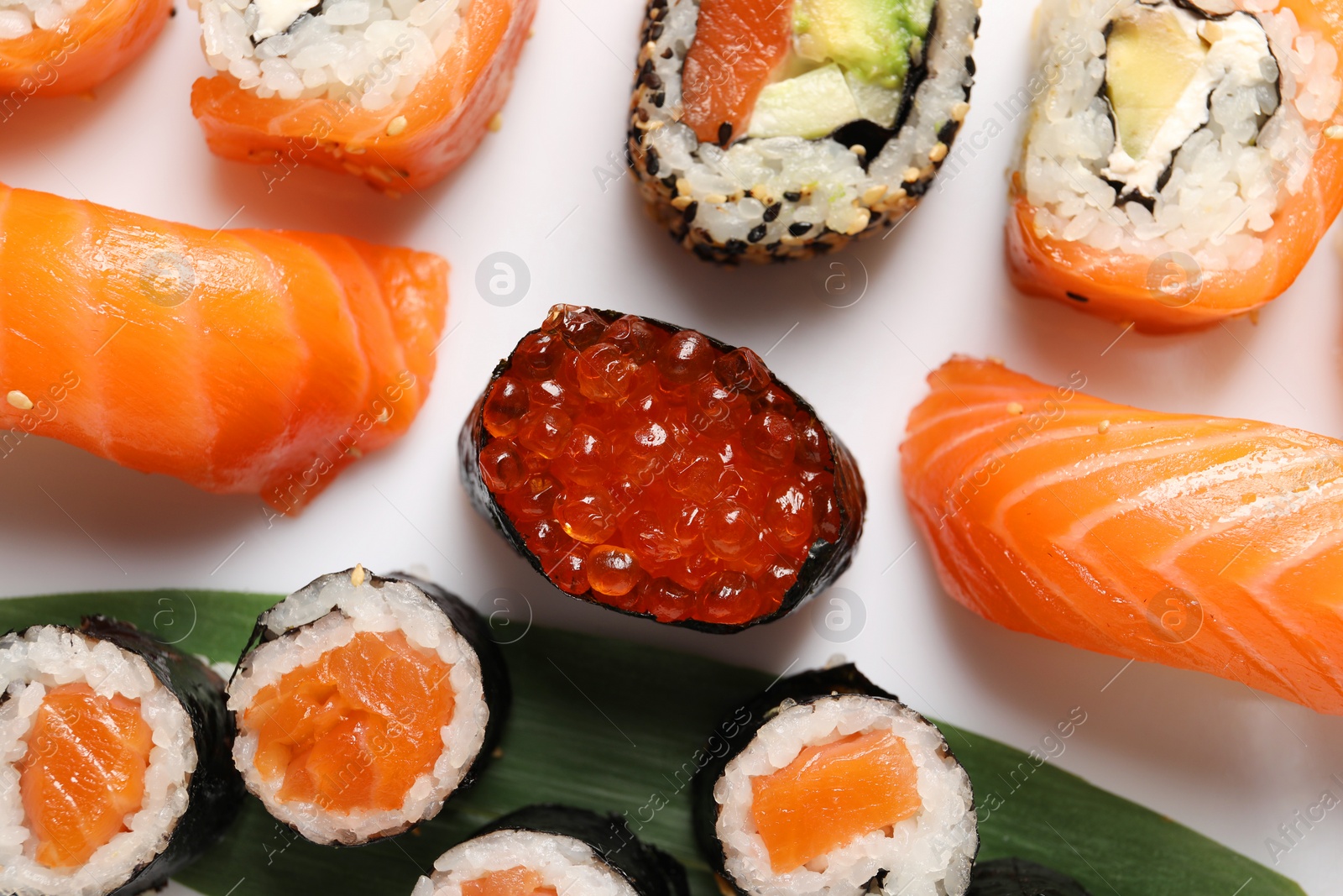 Photo of Different tasty sushi rolls on white background, flat lay