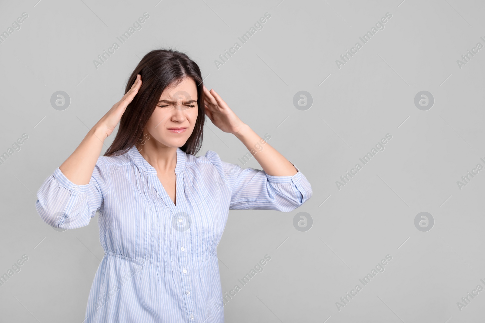Photo of Portrait of stressed young woman on grey background. Space for text