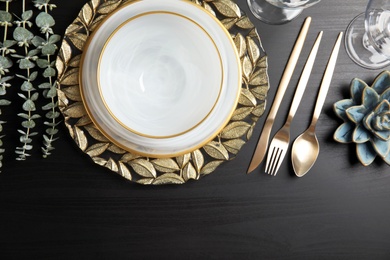 Elegant table setting on dark background, top view