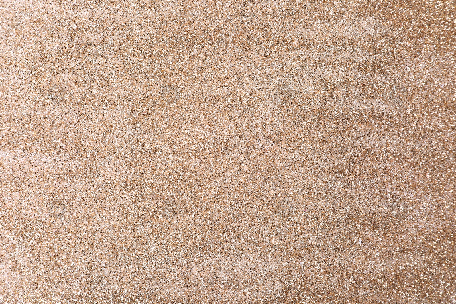 Photo of Shiny light brown glitter as background, closeup