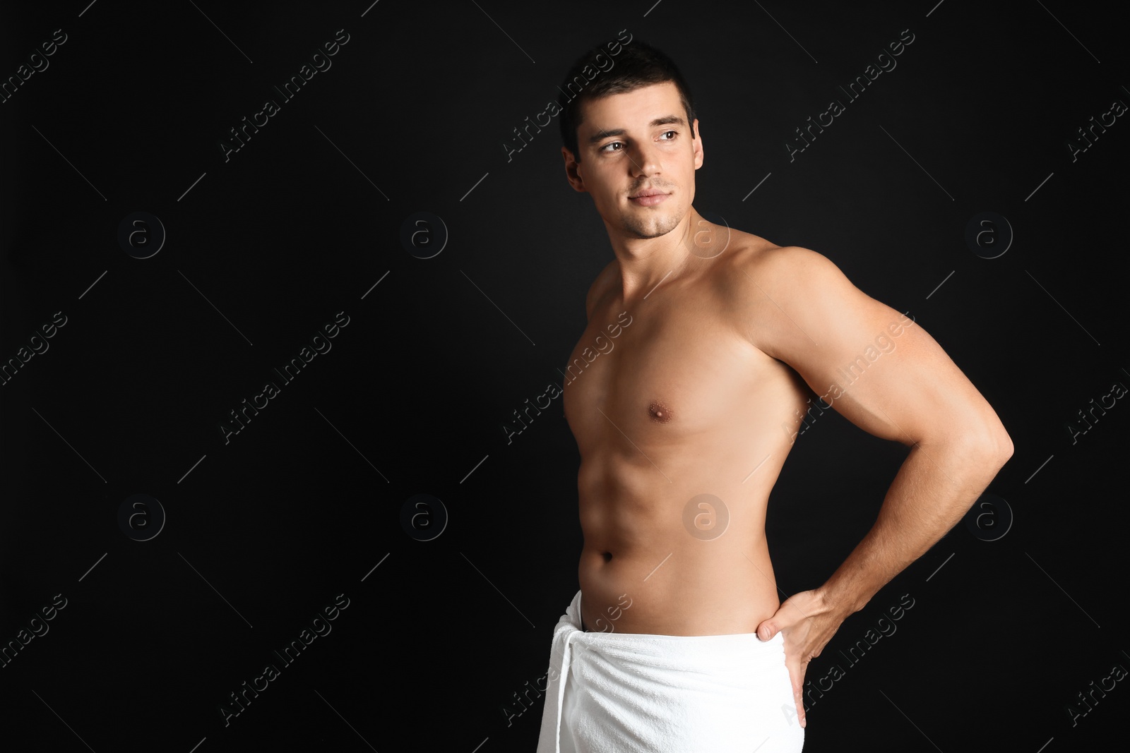 Photo of Man with sexy body on black background. Space for text