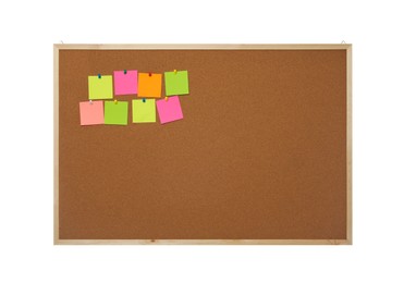 Photo of Empty notes pinned to cork board on white background