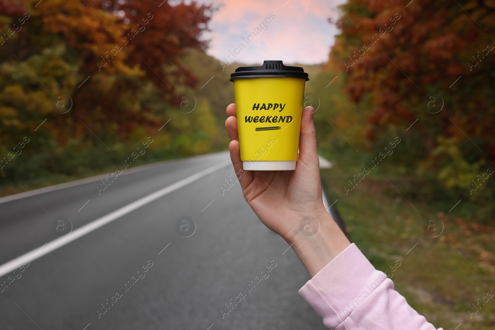 Image of Happy Weekend. Woman with takeaway coffee cup near road outdoors, closeup