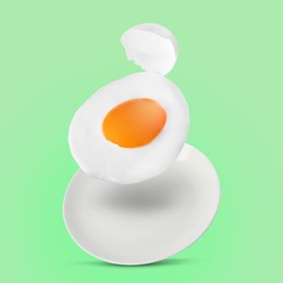 Image of Tasty fried chicken egg with shell falling into plate on color background