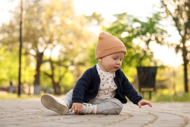 Portrait of little baby sitting in park