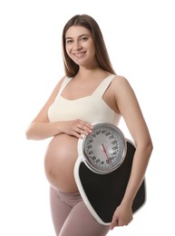 Pregnant woman with scales on white background