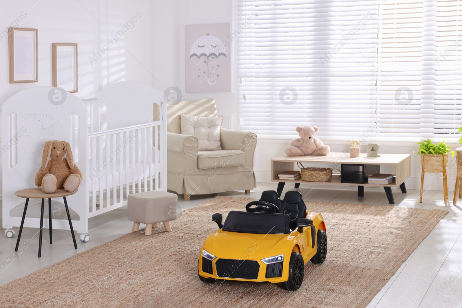 Photo of Yellow car in room at home. Child's toy