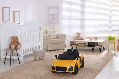 Photo of Yellow car in room at home. Child's toy