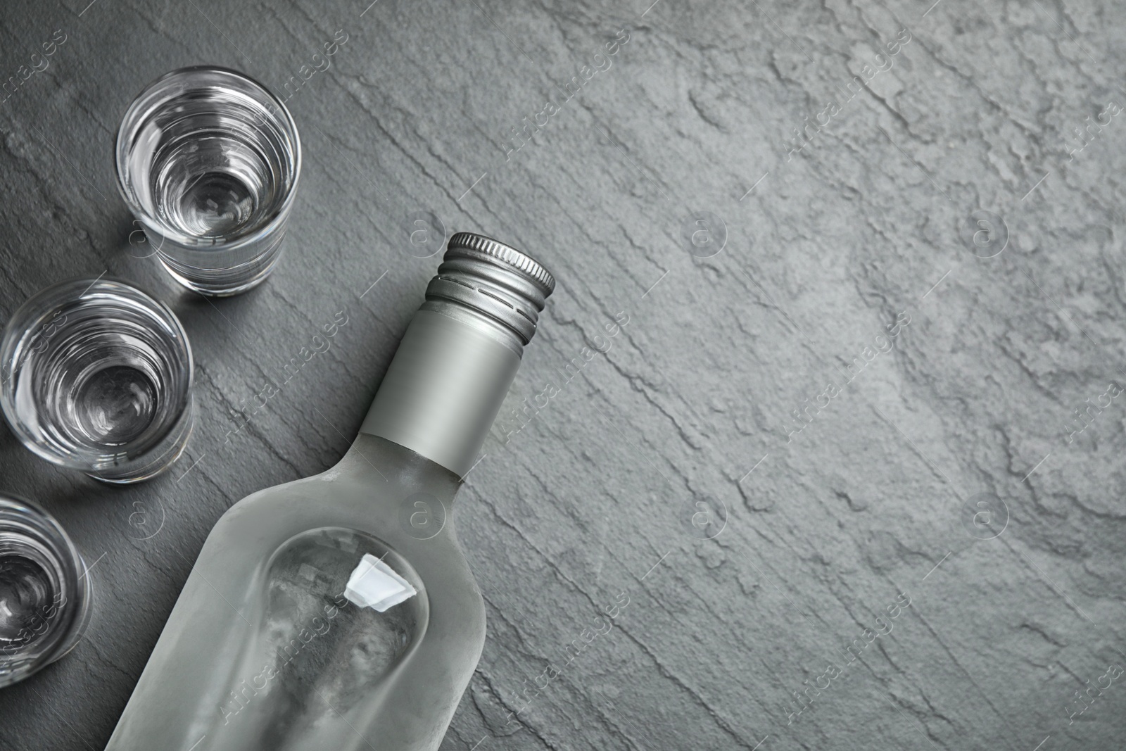 Photo of Cold Russian vodka on black table, flat lay. Space for text