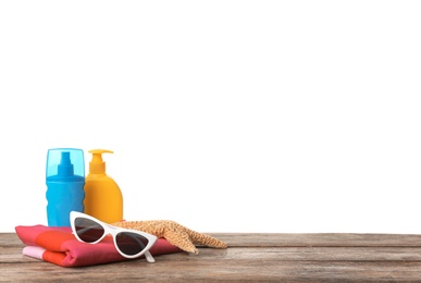 Set of different beach accessories on table against white background. Space for text