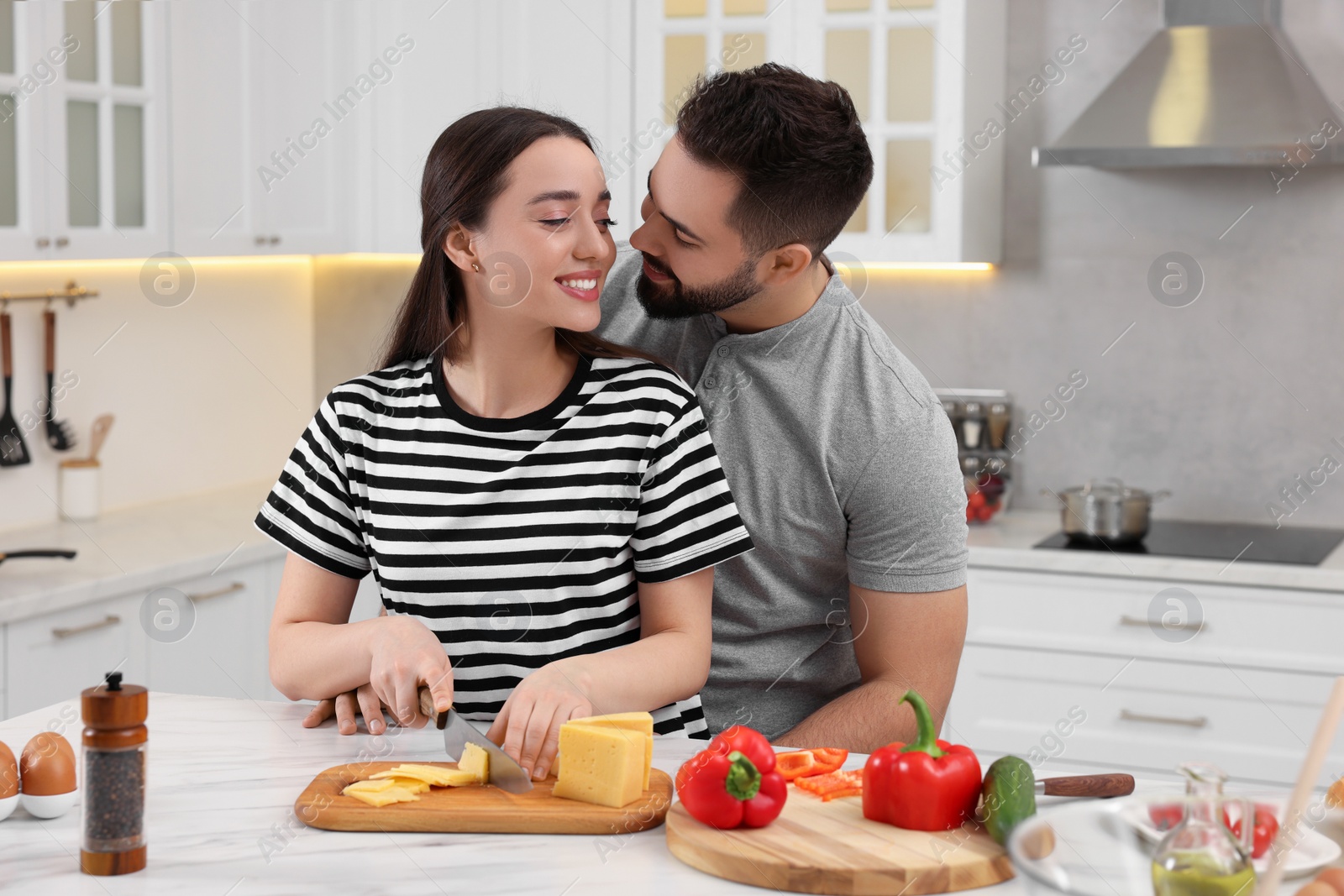 Photo of Lovely couple enjoying time together while cooking in kitchen