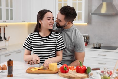 Photo of Lovely couple enjoying time together while cooking in kitchen