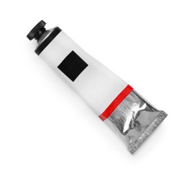 Photo of Tube with black oil paint on white background, top view
