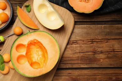 Flat lay composition with melon balls on wooden table, space for text