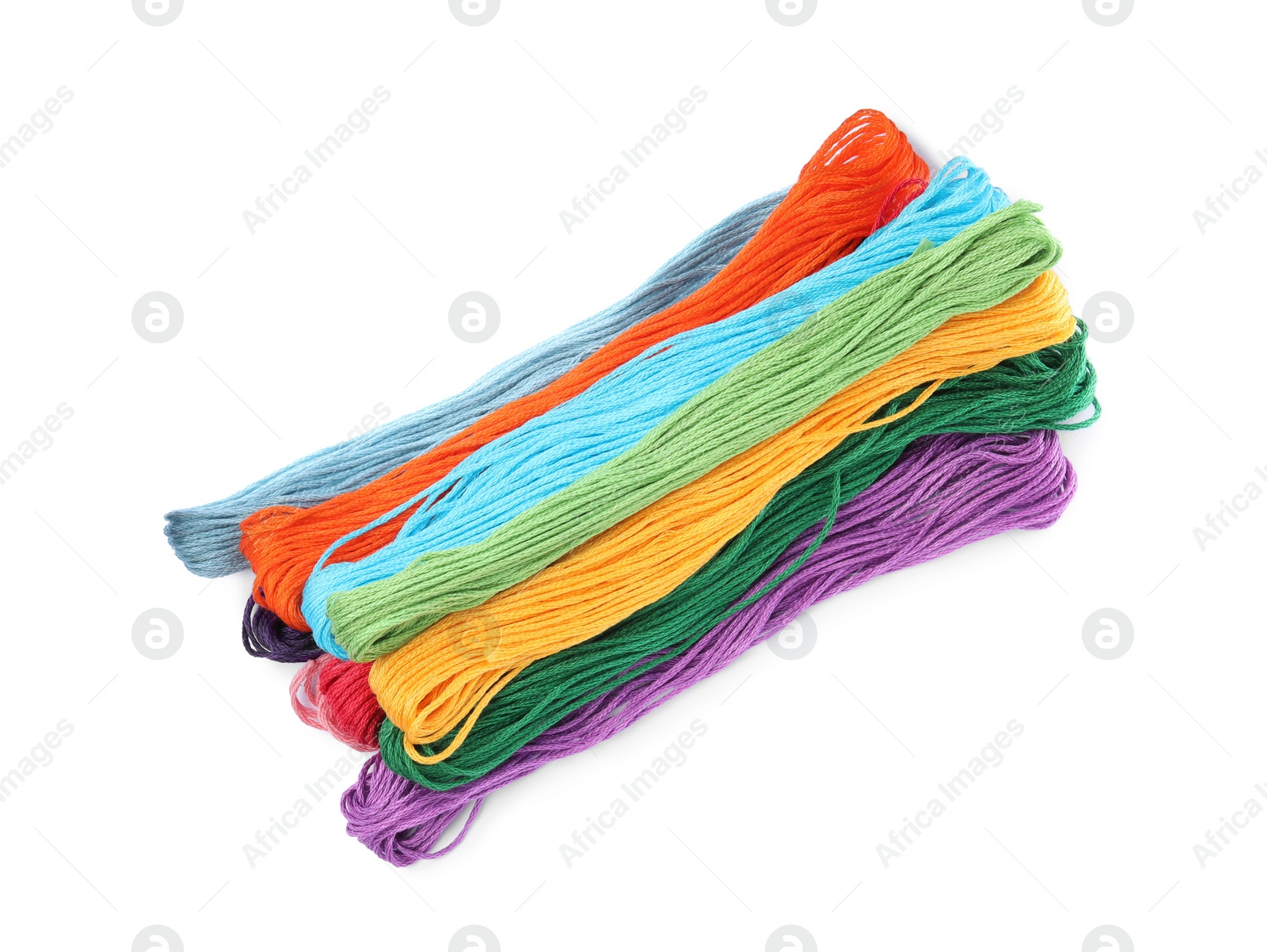 Photo of Set of colorful embroidery threads on white background, top view