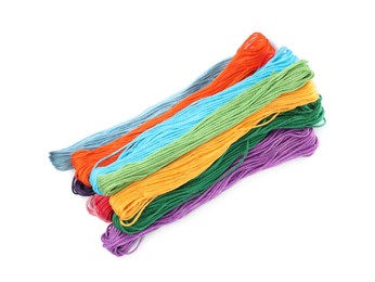 Set of colorful embroidery threads on white background, top view