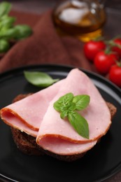 Photo of Delicious sandwich with ham on plate, closeup