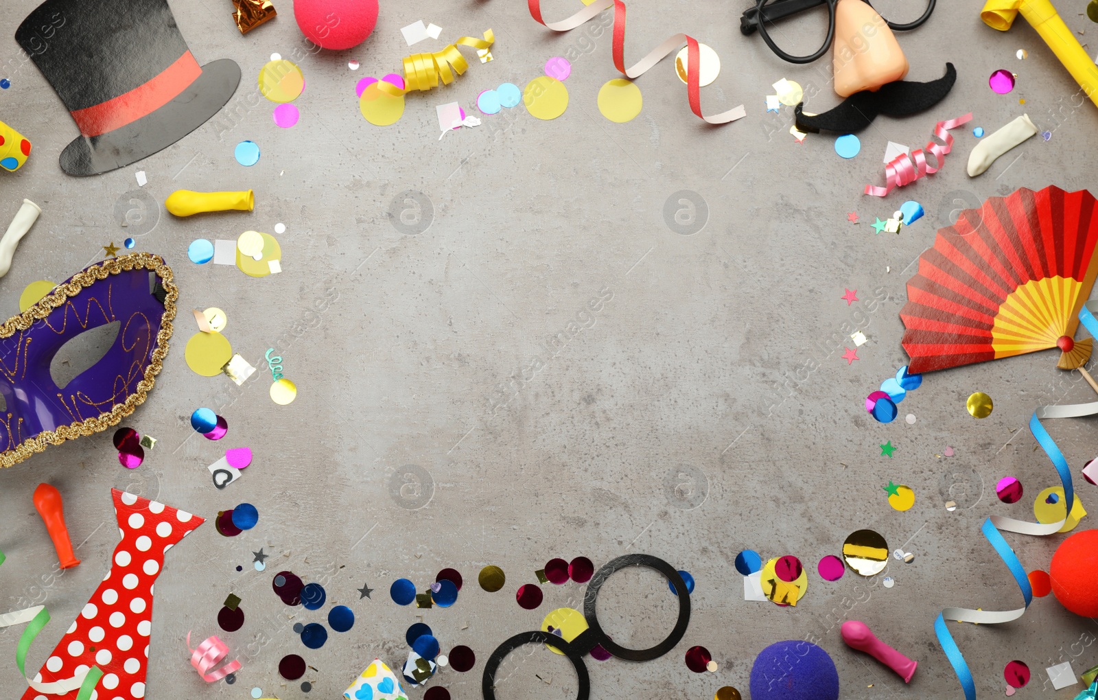 Photo of Frame of carnival items on grey background, flat lay. Space for text