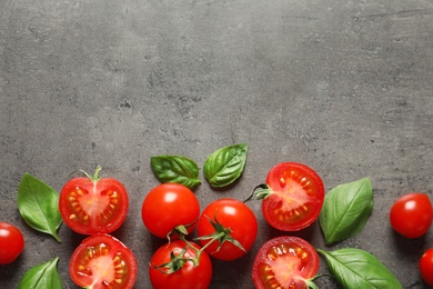 Photo of Flat lay composition with ripe cherry tomatoes and basil leaves on color background. Space for text