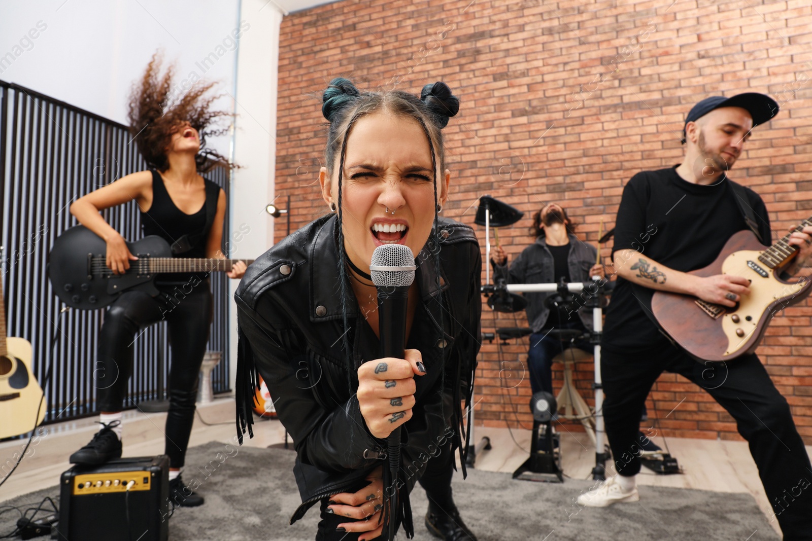 Photo of Music band performing in modern recording studio