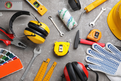 Flat lay composition with different construction tools on grey marble background