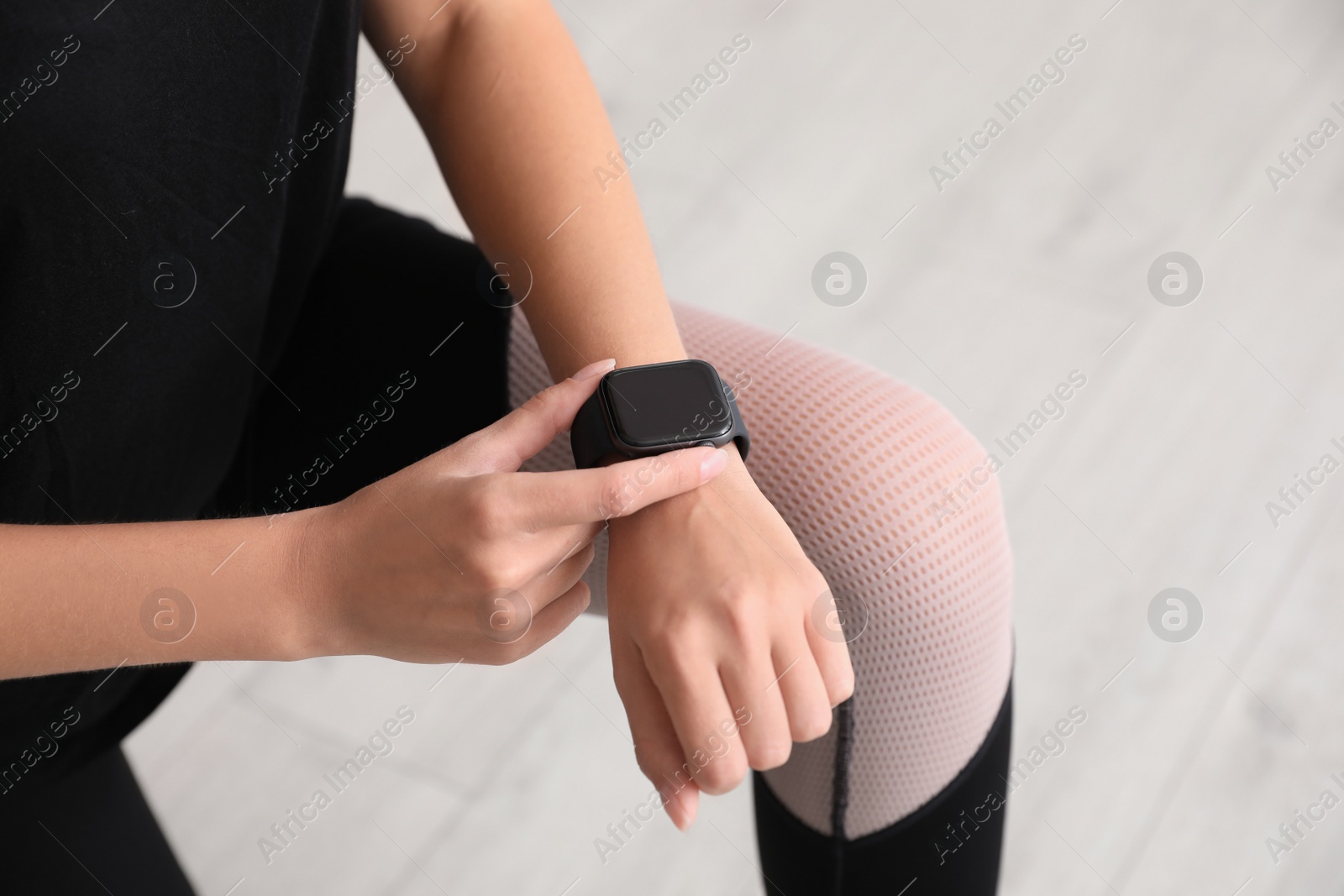 Image of Woman using stylish smart watch indoors, closeup