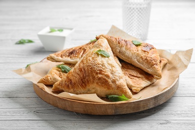 Fresh delicious puff pastry on white wooden table