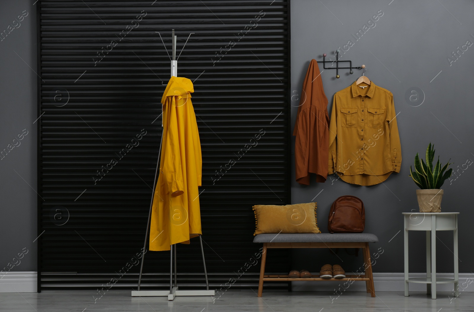 Photo of Hallway interior with stylish furniture, clothes and accessories