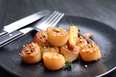 Delicious fried scallops served on dark gray table, closeup