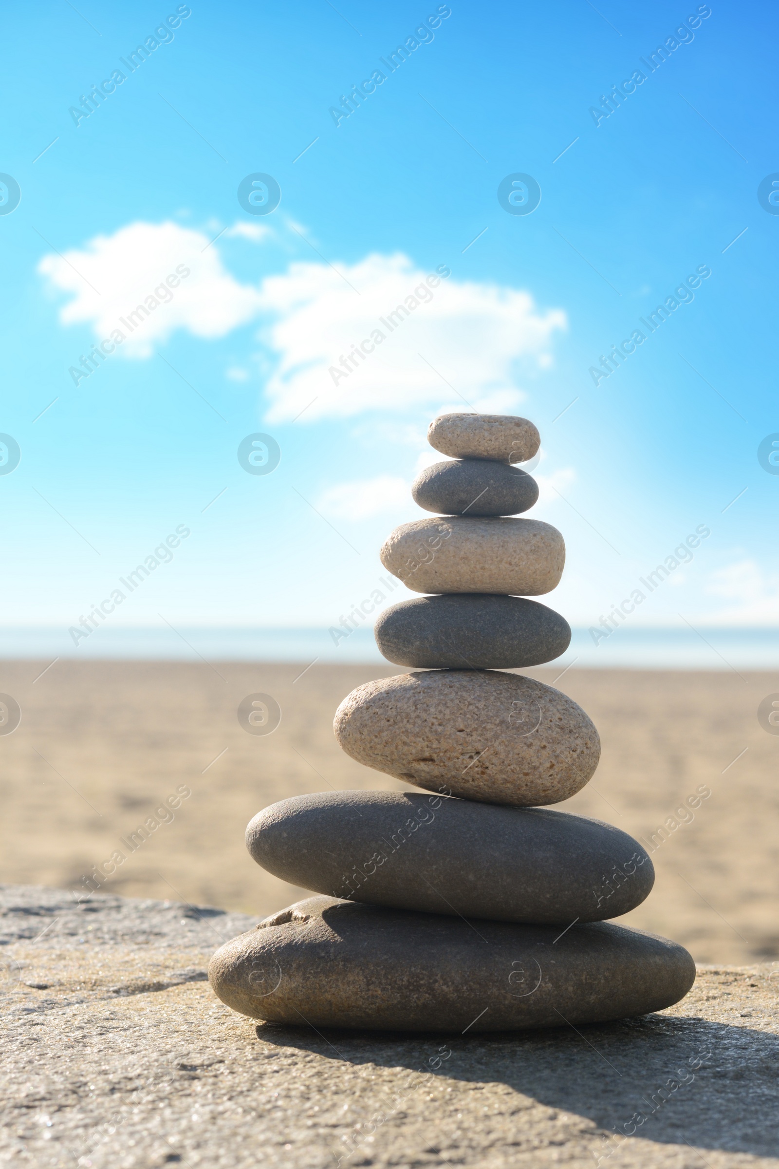 Photo of Stack of stones on parapet near sea