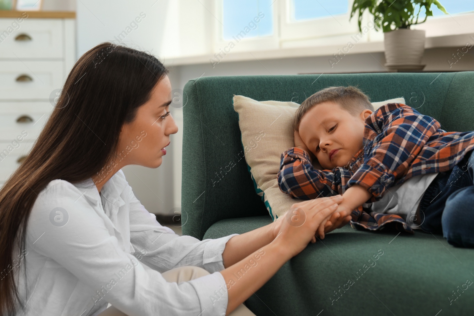 Photo of Psychologist working with unhappy little boy in office. Mental health problems