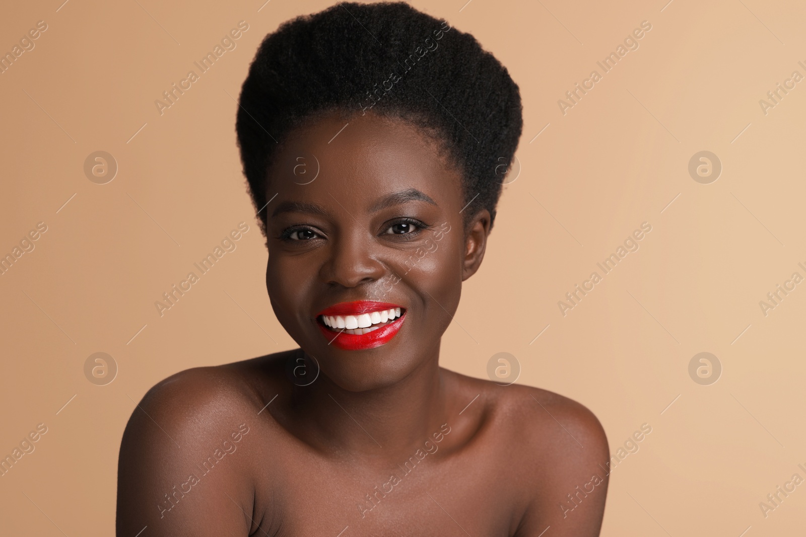 Photo of Portrait of beautiful happy woman on beige background