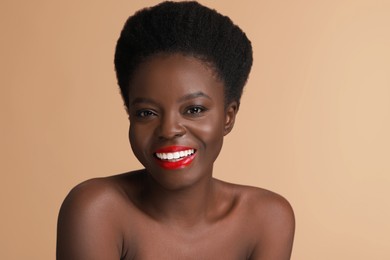 Photo of Portrait of beautiful happy woman on beige background