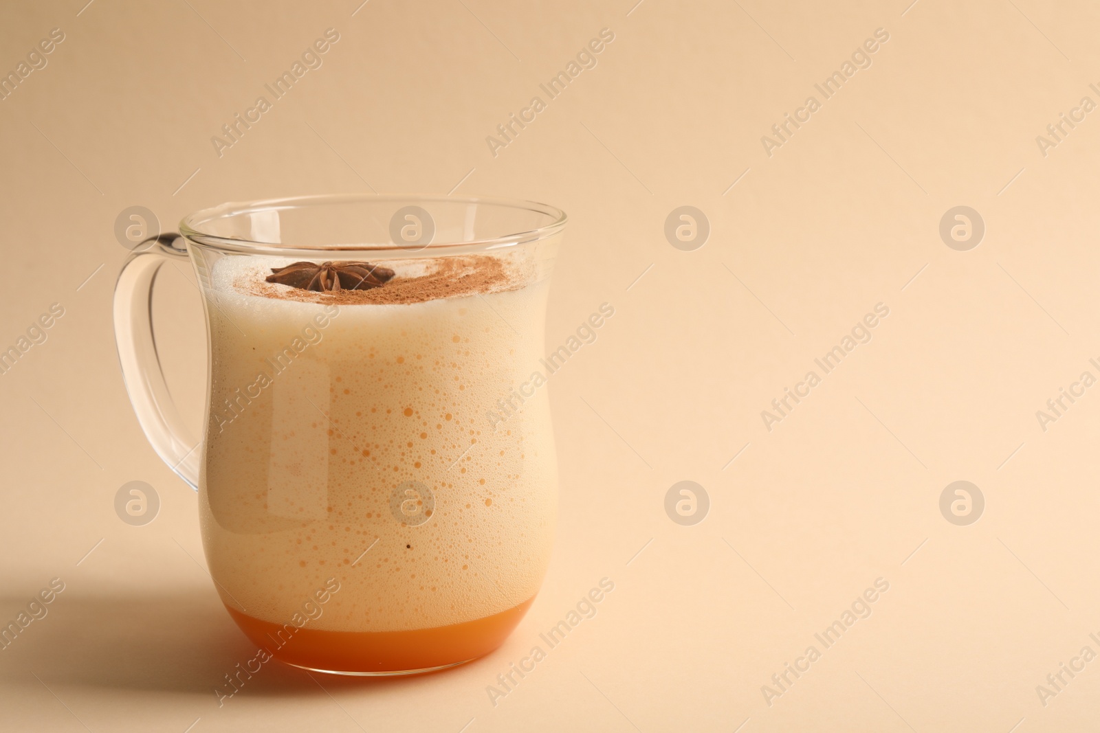Photo of Delicious eggnog with anise on beige background. Space for text