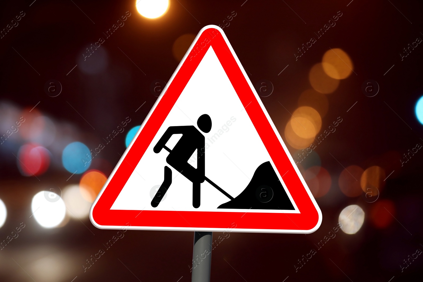 Image of Traffic sign Road Works on city street in night. Bokeh effect