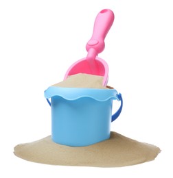 Plastic toy bucket with pink shovel and sand on white background