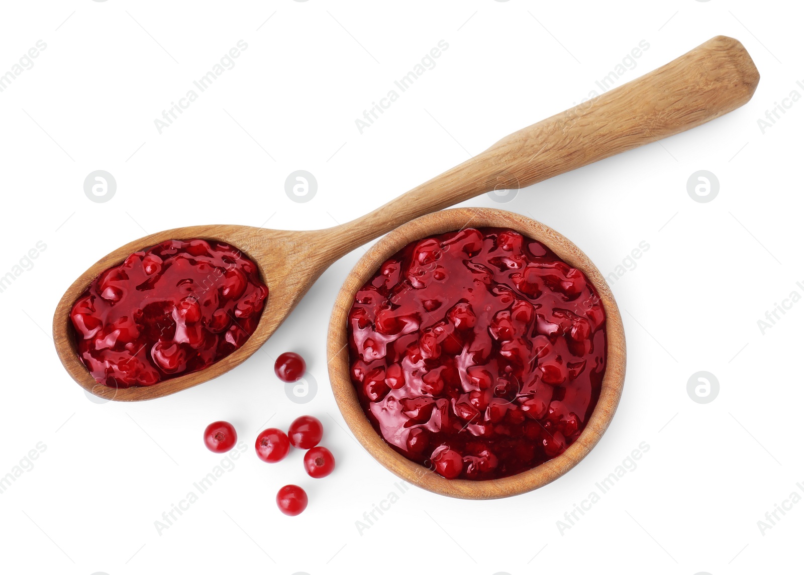 Photo of Tasty cranberry sauce in bowl, spoon and fresh berries isolated on white, top view