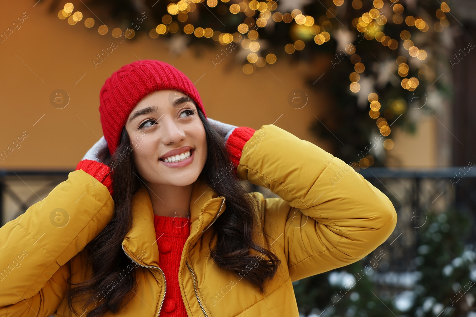 Photo of Portrait of smiling woman on city street in winter. Space for text