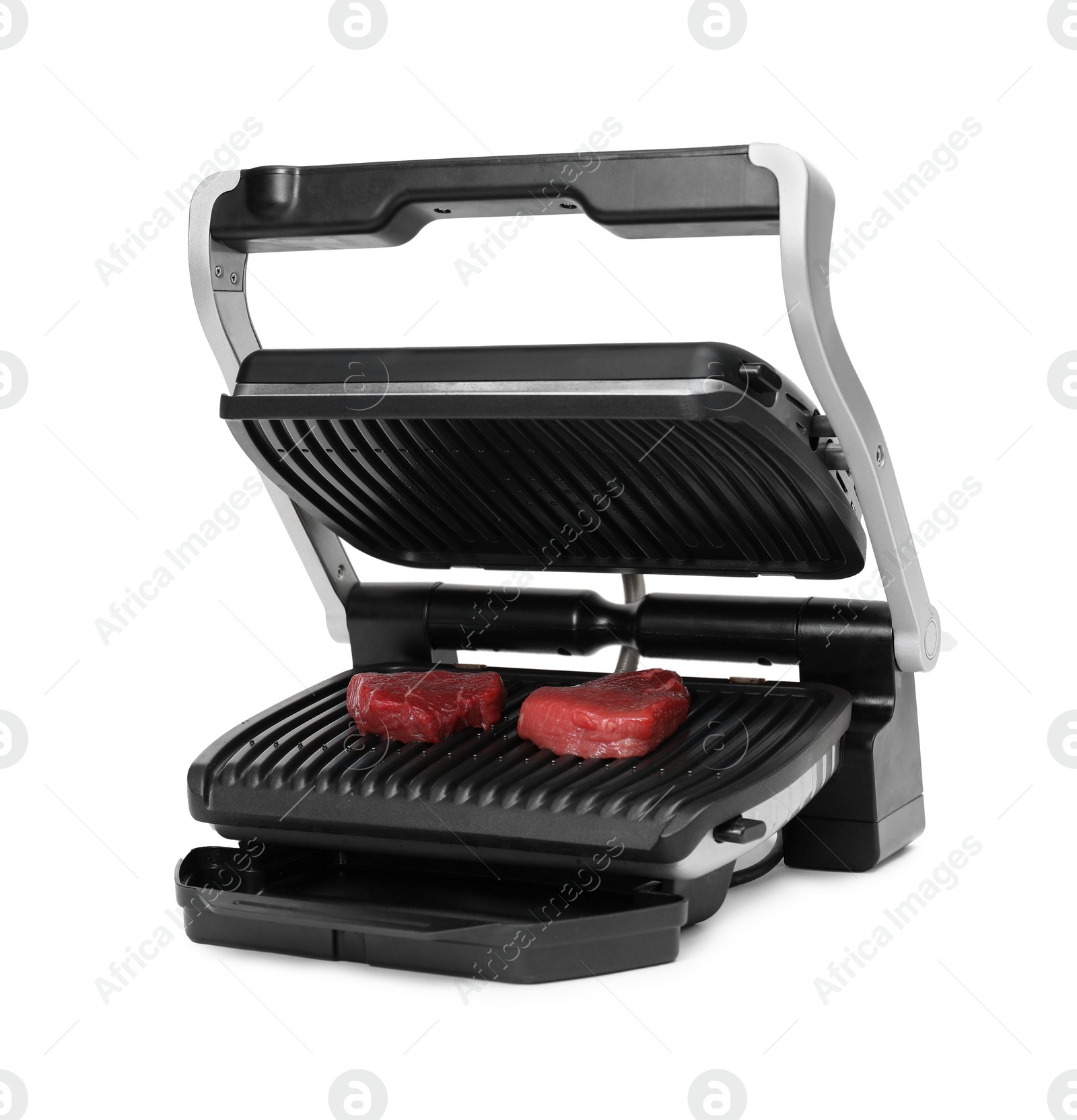 Photo of Electric grill with raw meat steaks isolated on white