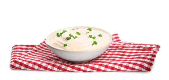 Fresh sour cream with onion and fabric on white background