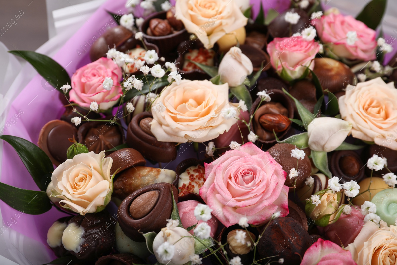 Photo of Beautiful food bouquet of sweets and flowers, closeup