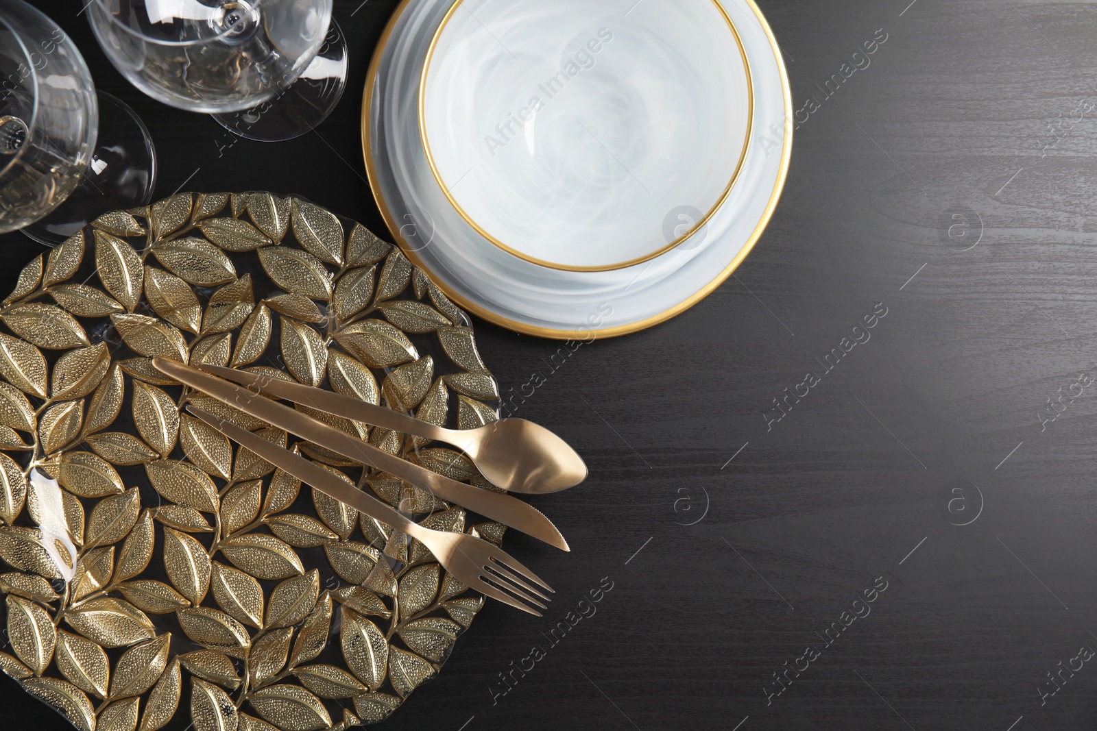 Photo of Elegant table setting and space for text on dark background, top view