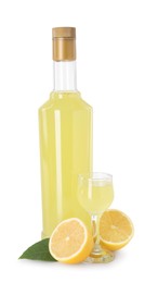Photo of Tasty limoncello liqueur, halves of lemon and green leaf isolated on white