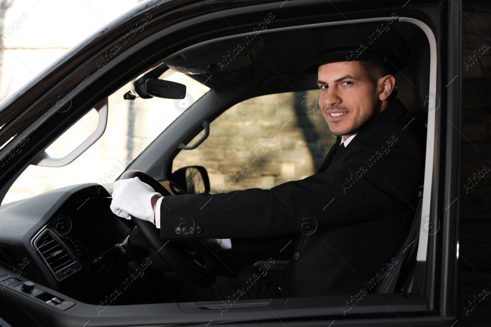 Photo of Professional driver in luxury car. Chauffeur service