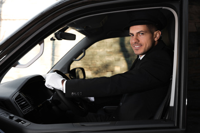 Photo of Professional driver in luxury car. Chauffeur service