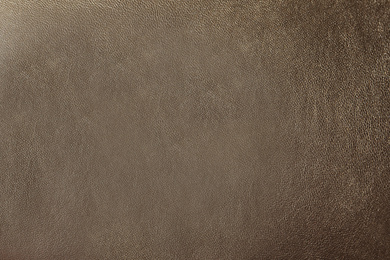 Photo of Texture of light brown leather as background, closeup