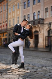 Lovely young couple together on city street. Romantic date