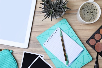 Flat lay composition with notebooks, coffee and beauty blogger's stuff on wooden table