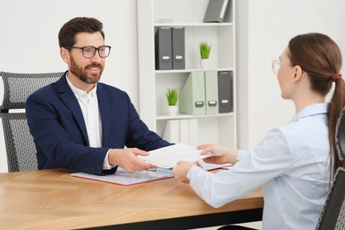 Businesspeople working with documents at table in office